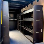 Large van racking with desk and full-length driver-side tool storage system by Ply Van Racking Ltd