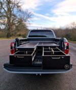 Pickup bed pull-out drawers with removable dividers and central pipe storage sections by Ply Van Racking Ltd