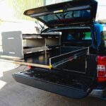 Pickup truck drawer and racking unit with two deep pull-out drawers and upper sliding bed system by Ply Van Racking Ltd