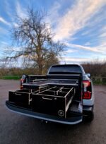 Pickup truck tool drawer system with slide-out work surface above left drawer by Ply Van Racking Ltd